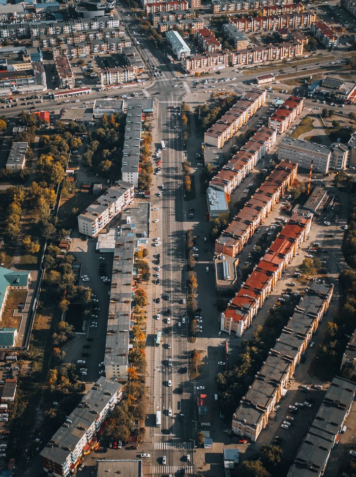 A stunning aerial view of an urban cityscape featuring residential buildings and busy roads.
